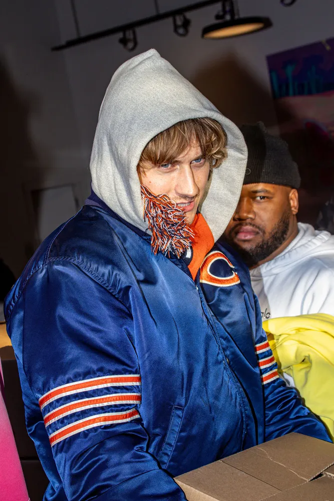 Close-up portrait of a person in a blue jacket and gray hood