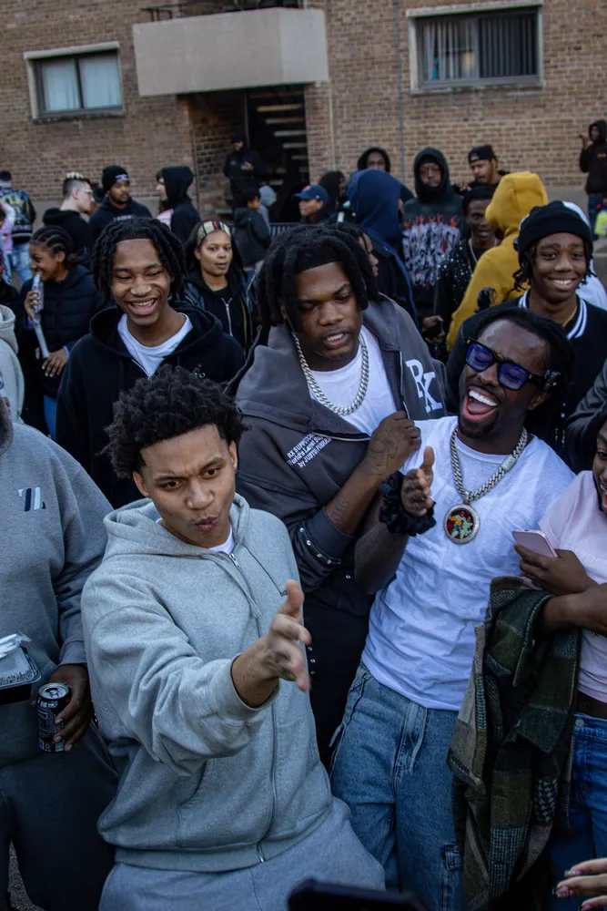 Group portrait with a crowd gathered outside a building