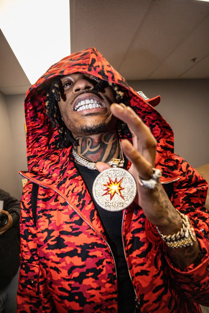 Portrait of a smiling man in a red patterned hood