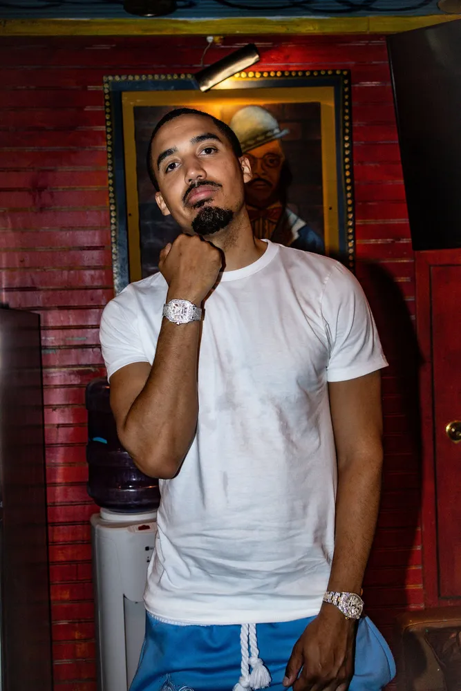 Portrait of a man in a white shirt outside a brick building
