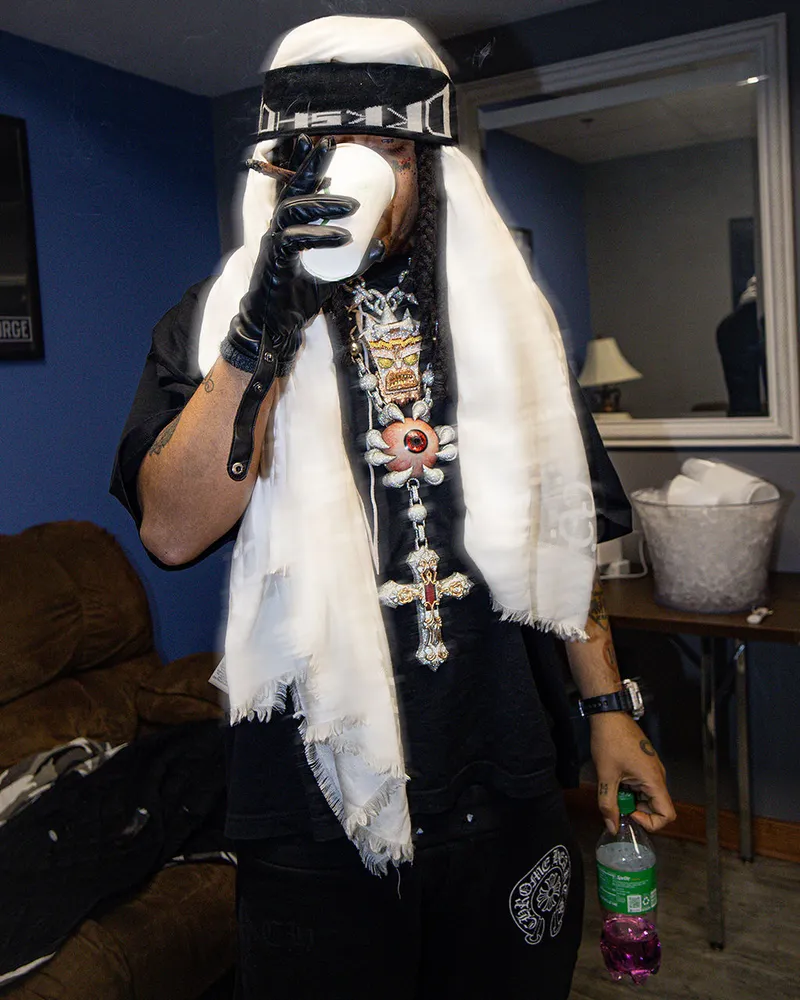 Portrait with a white head covering, gloves, and layered jewelry