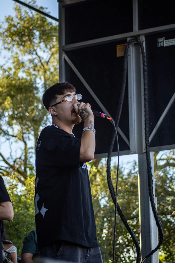 Performer holding a microphone on an outdoor stage
