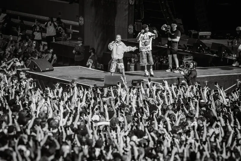 Black-and-white view across a packed festival crowd