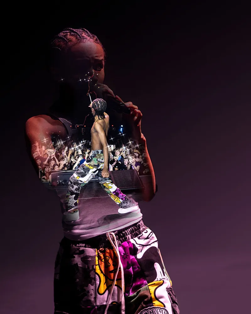 Performer holding a microphone against a dark backdrop