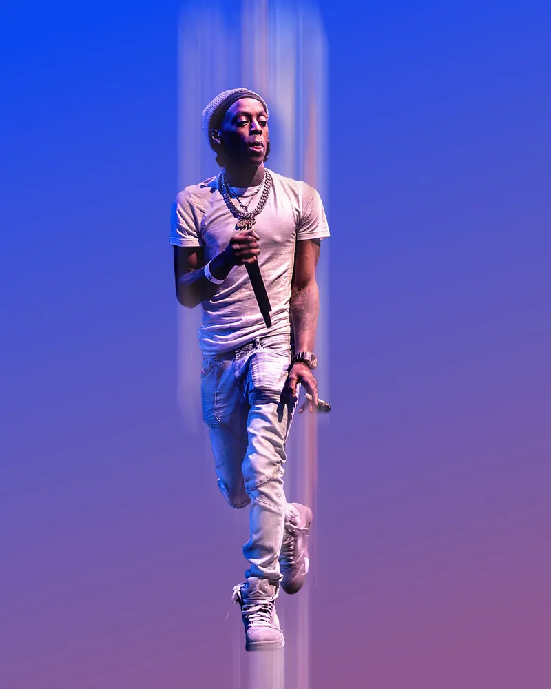 Performer under blue lighting against a clear stage backdrop