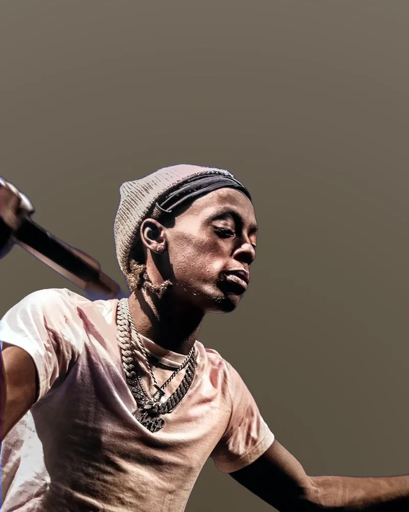 Close-up performance portrait with a microphone and head wrap